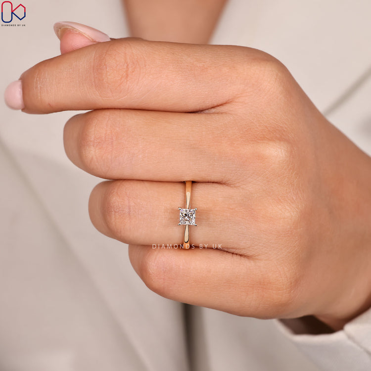 Princess cut solitaire ring with tapered shank.
