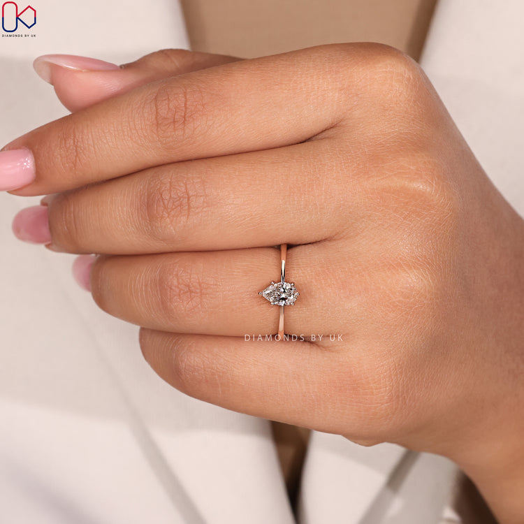 Pear cut diamond ring with tapered shank design.