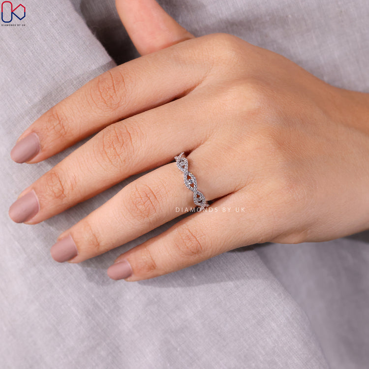 Evil eye half eternity band with twisted diamond style.
