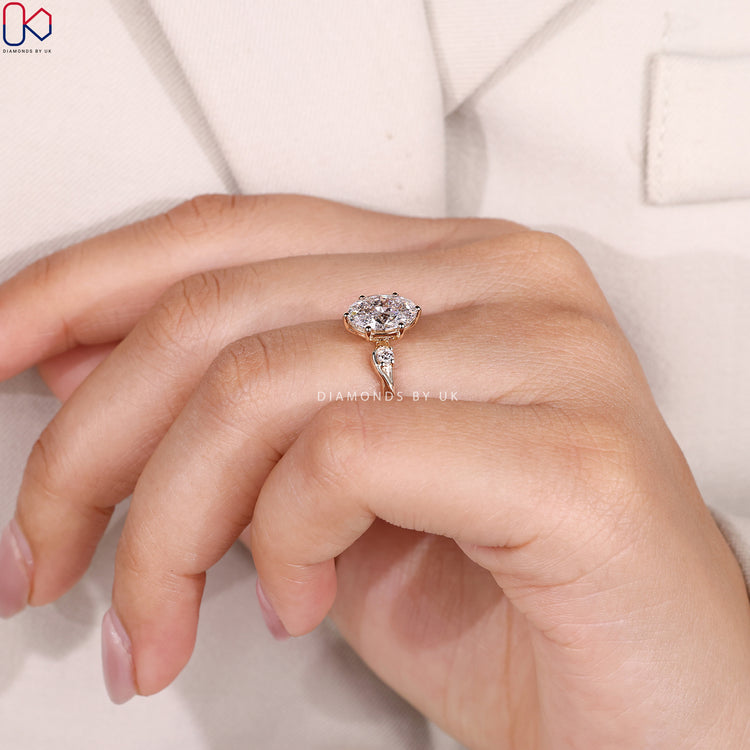 Lab grown oval ring with round diamond side stones.