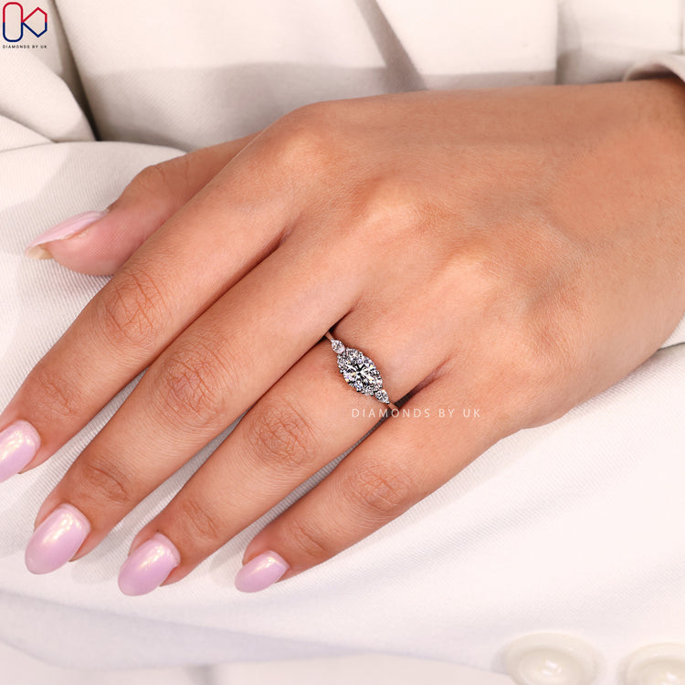 Lab grown round cut ring with marquise accents.