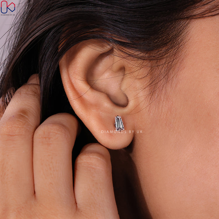 Baguette cut lab grown diamond earrings with prongs.