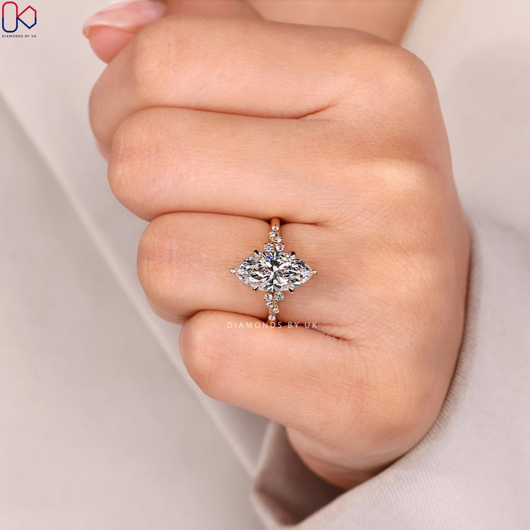 Six claw marquise diamond ring with side stones.
