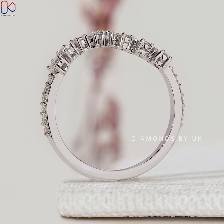 Lab grown round diamond band with curved prong setting.