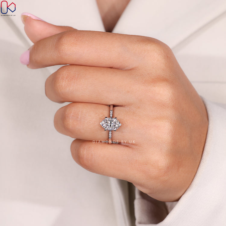 Oval diamond ring with V and claw prong setting.
