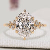 Oval diamond ring with round side stones and muse setting.  
