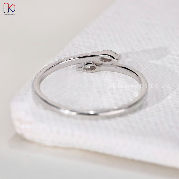 Handmade diamond band with bypass and prong setting.