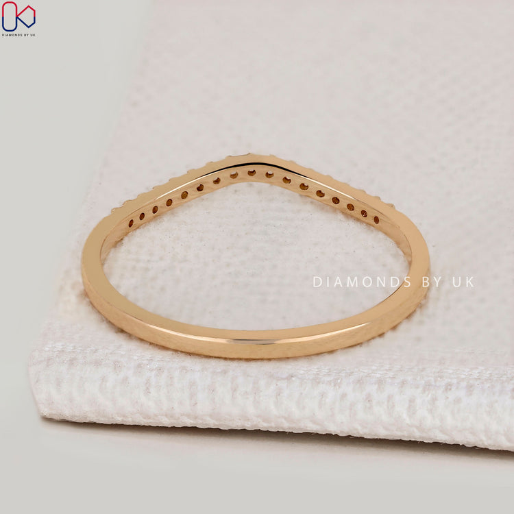 Handmade curved diamond band with round stones.
