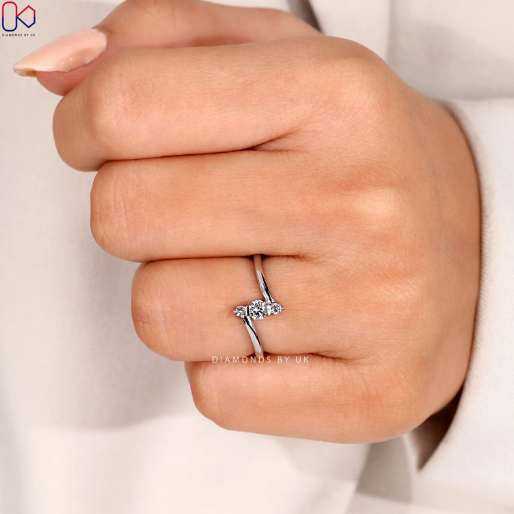 Three stone ring with vertical bar setting style.
