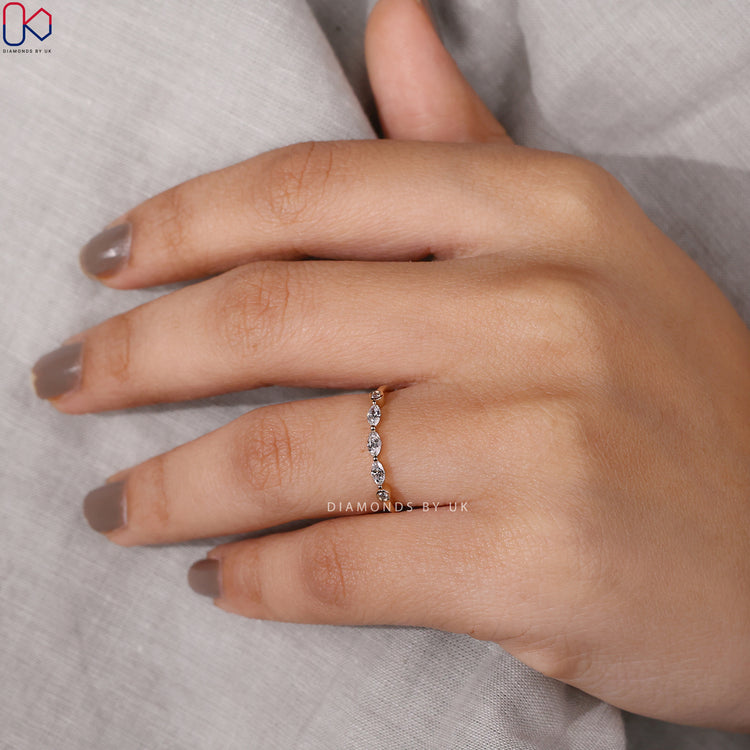 Marquise and round diamond band with shared prong setting.
