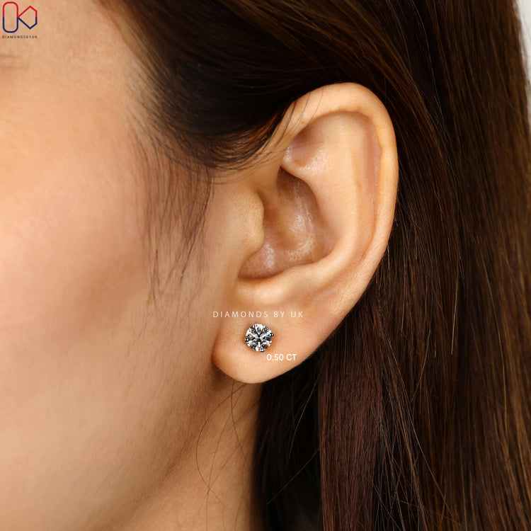 Round cut diamond studs with screw back setting.  
