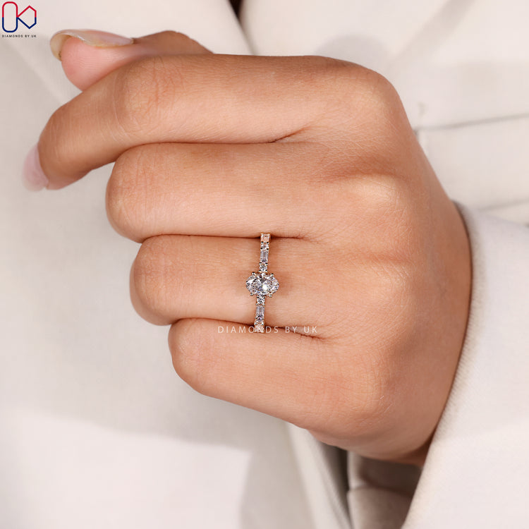 Shared prong oval ring with baguette side stones.