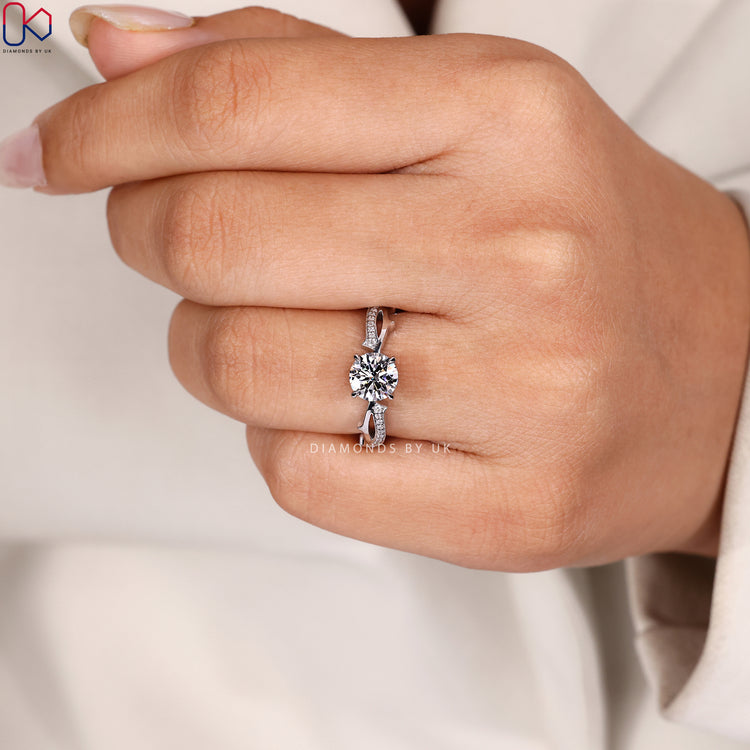 Hidden halo round cut ring with four claws.