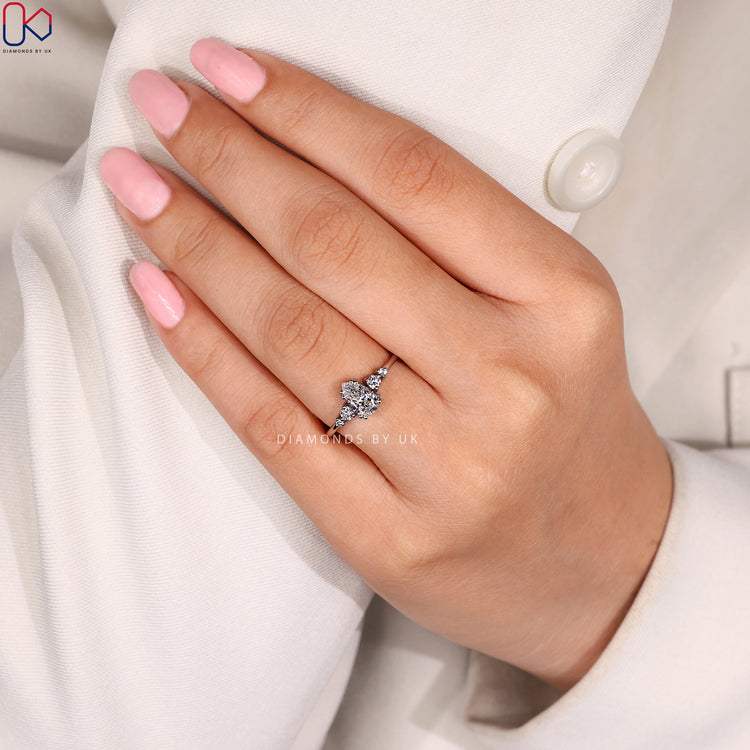 Five stone pear cut ring with muse setting style.