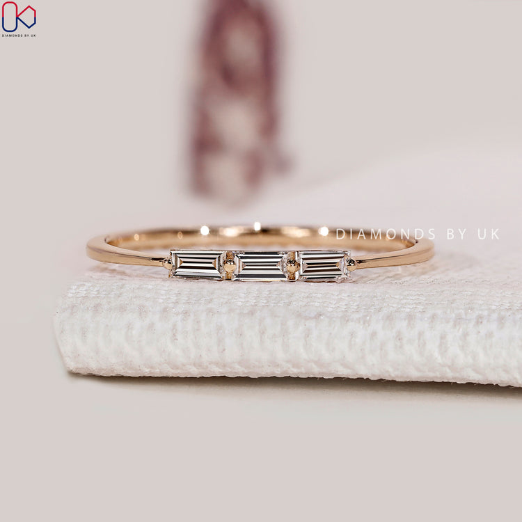 Baguette diamond band with three stone style setting.
