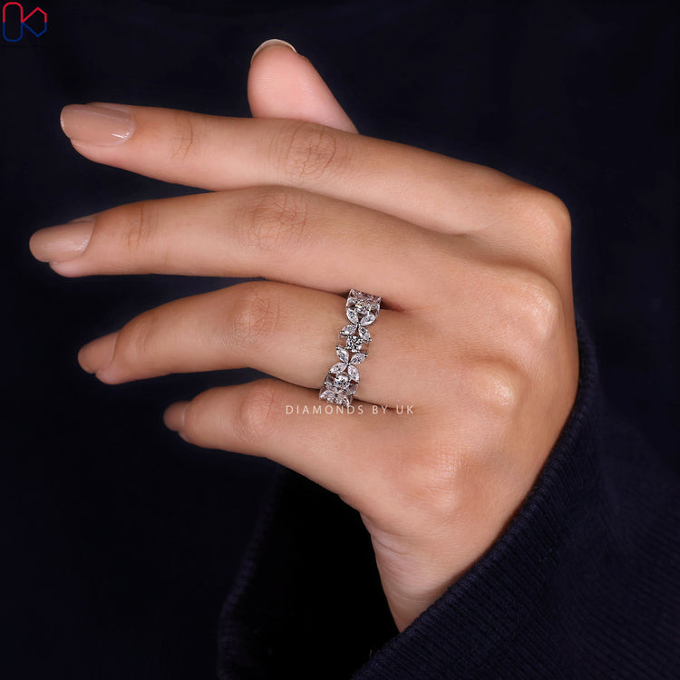 Round and marquise diamond band with floral prong setting.