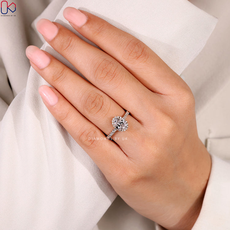 Oval diamond ring with four claw prong setting.