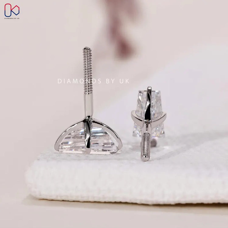 Handmade baguette diamond earrings with compass prongs.