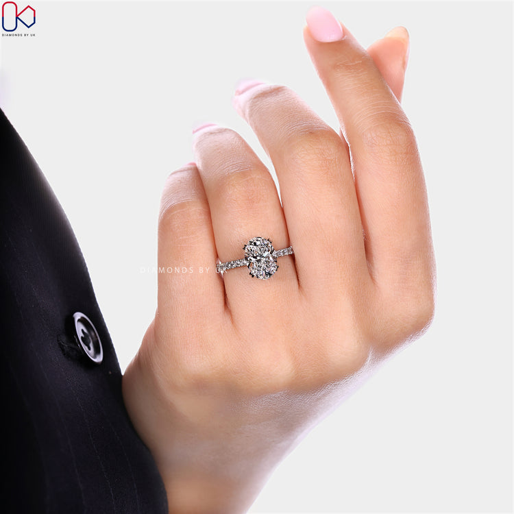 Oval cut lab grown diamond ring with double claw prongs.
