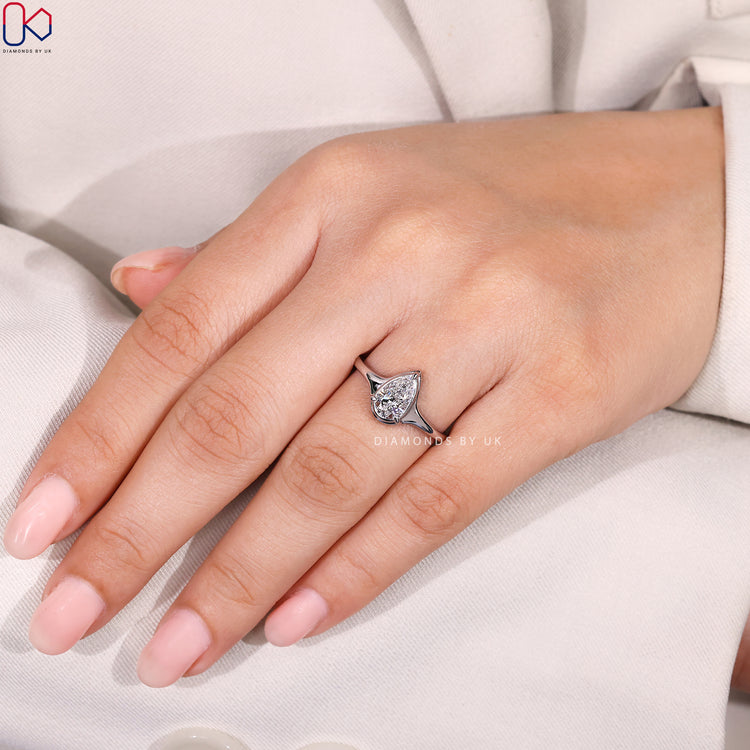 Pear diamond ring with three prong bezel style.