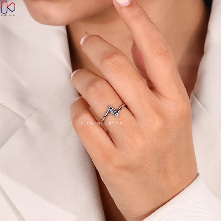 Three stone diamond ring with vertical bar setting.
