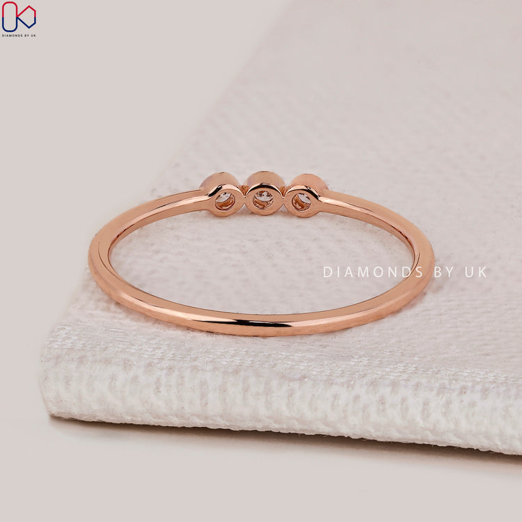 Three stone round diamond band with milgrain setting.
