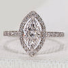 Marquise cut ring with halo and round diamond pavé.
