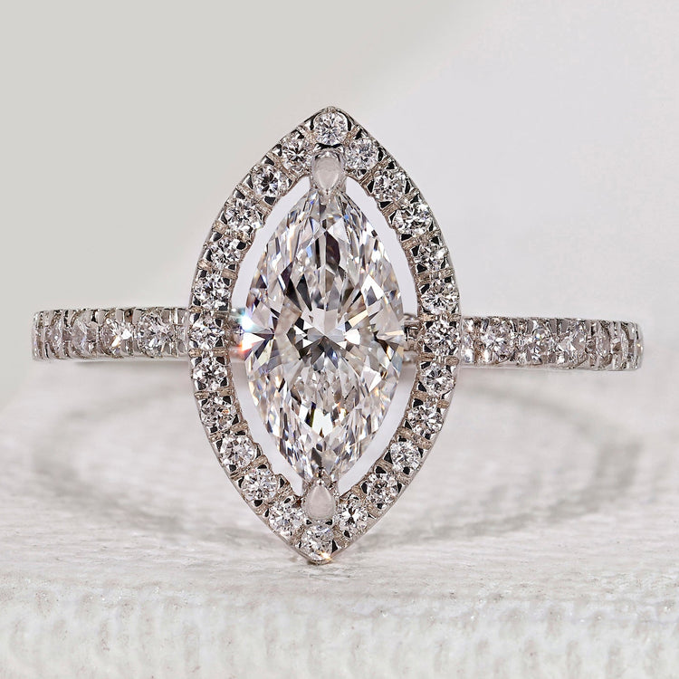 Marquise cut ring with halo and round diamond pavé.
