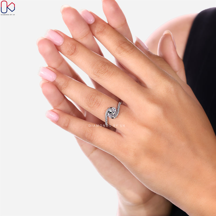 Oval ring with round diamond pavé bypass style.
