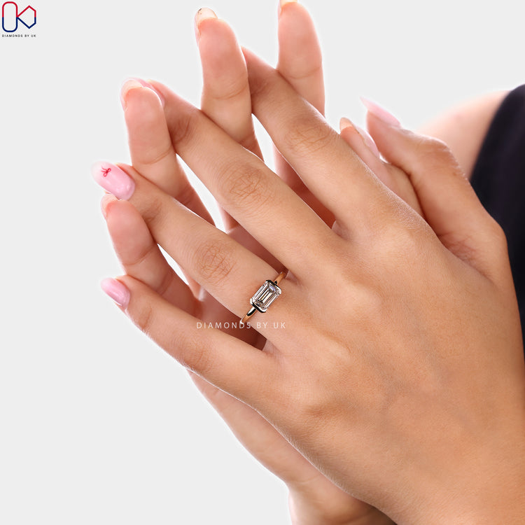 East to west emerald cut diamond solitaire ring
