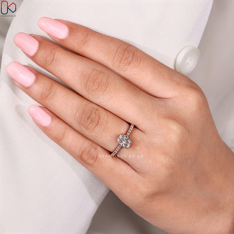 Cushion cut ring with cathedral and hidden halo.