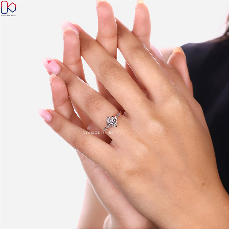 Oval cut diamond ring with pear and round diamonds.
