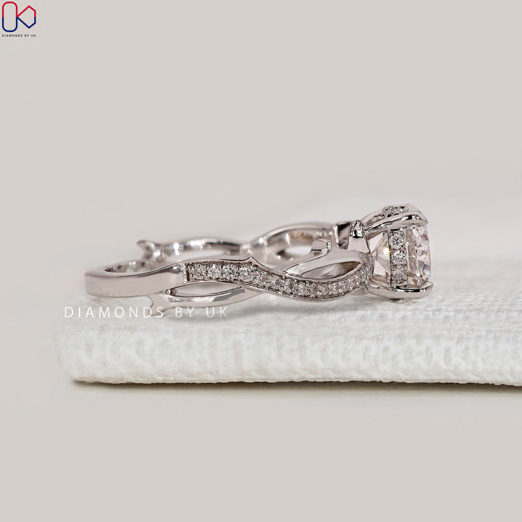 Handmade round cut ring with four claw prongs.
