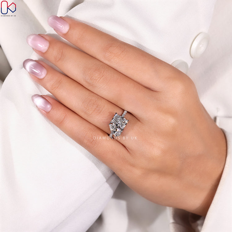 Radiant and pear engagement ring with pavé style.