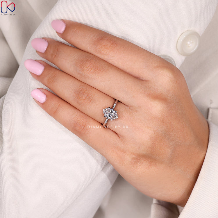 V and claw prong oval cut diamond ring.