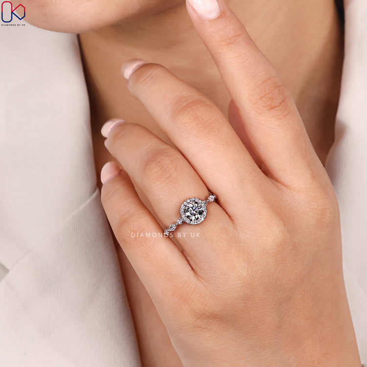 Round cut diamond ring with halo pavé design.