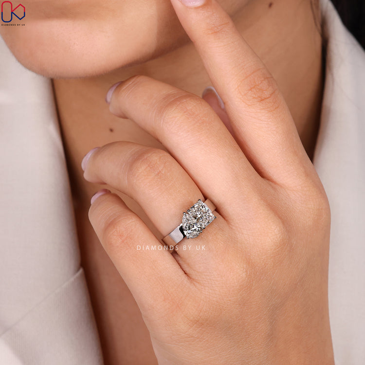 Radiant and pear diamond ring with claw setting.