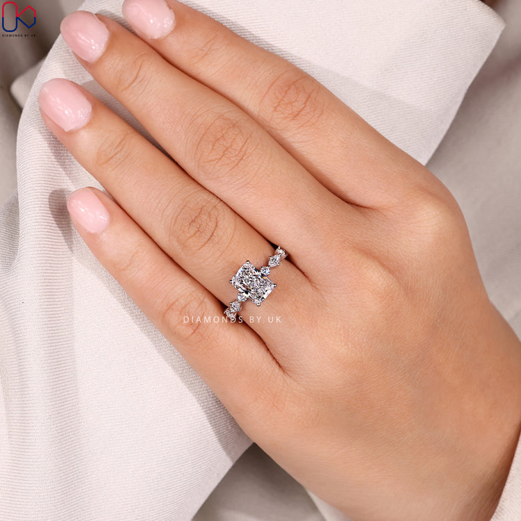 Radiant cut ring with four prong pavé style.