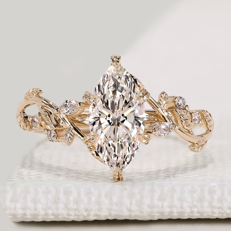 Marquise diamond ring with marquise and round side stones.
