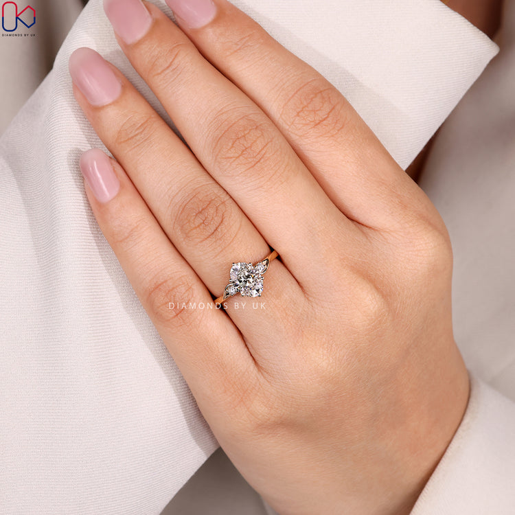 Oval engagement ring with three stone design.