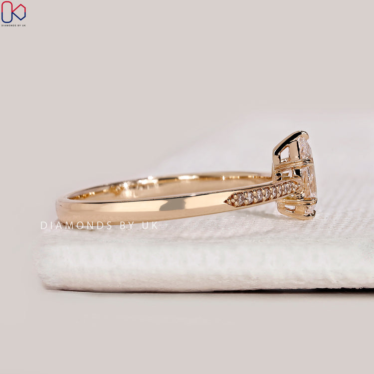 Handmade pear cut ring with tapered pavé style.