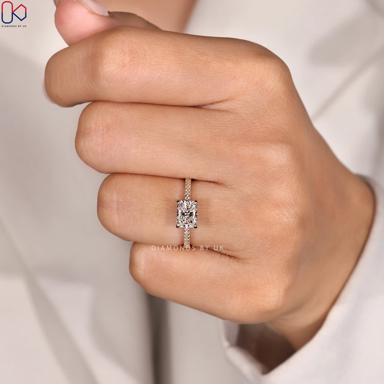 Radiant cut ring with hidden halo and pavé band.