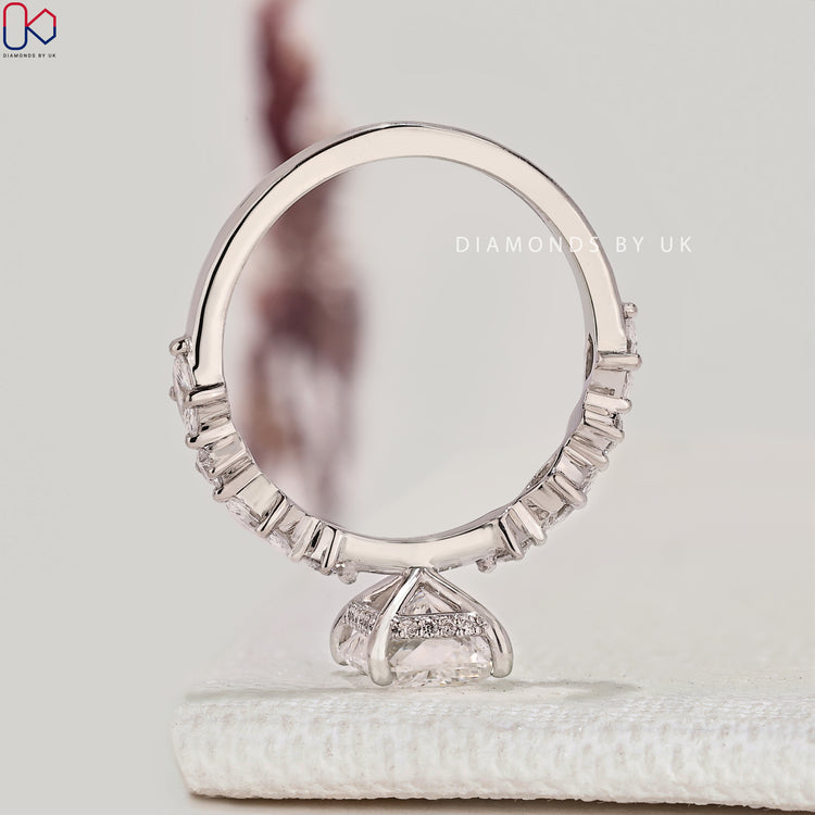 Handmade radiant engagement ring with marquise stones.
