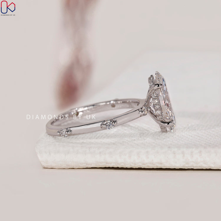 Marquise diamond ring with a round diamond hidden halo.
