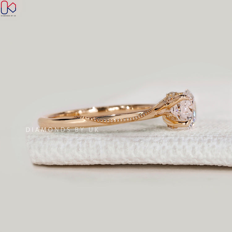 Handmade round cut ring with four claw prongs
