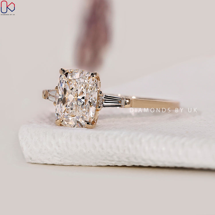 Side Stone Engagement Ring featuring a dazzling centre diamond.
