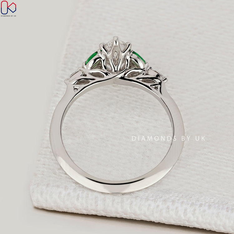 IGI Certified marquise diamond ring with emeralds.