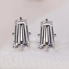 Tapered baguette diamond earrings with solitaire stud style.