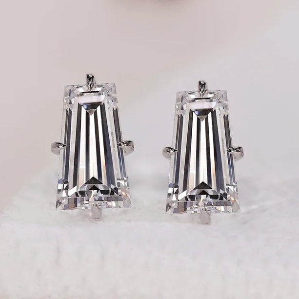 Tapered baguette diamond earrings with solitaire stud style.