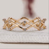 Round cut diamond band with crossover style.
